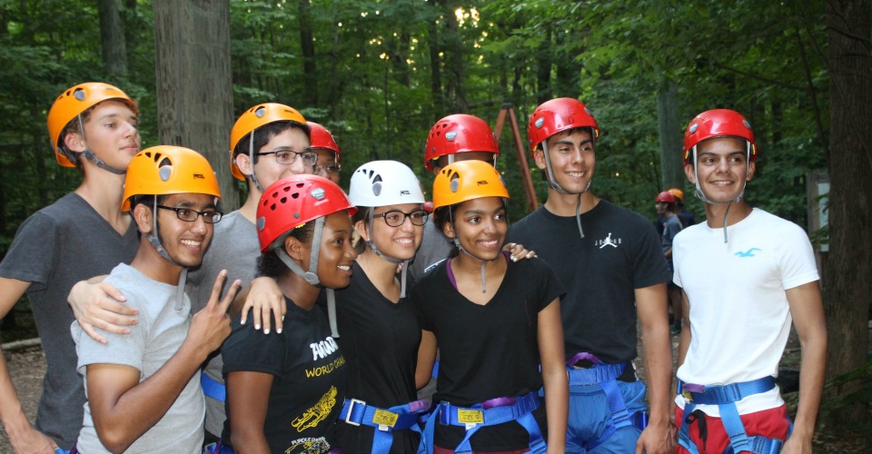 Group of participants in safety helmets at Hoffman Challenge ropes course