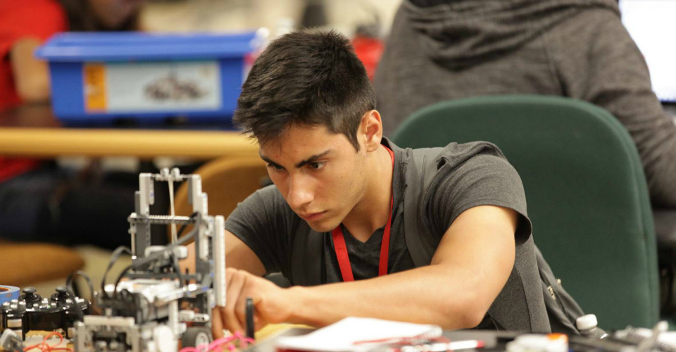 Male participant adjusts his LEGO Mindstorm robot