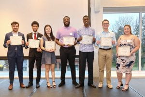 Seven of eight DPE Scholar awardees at the 2022 banquet. Awardees of mixed races and genders, all holding certificates