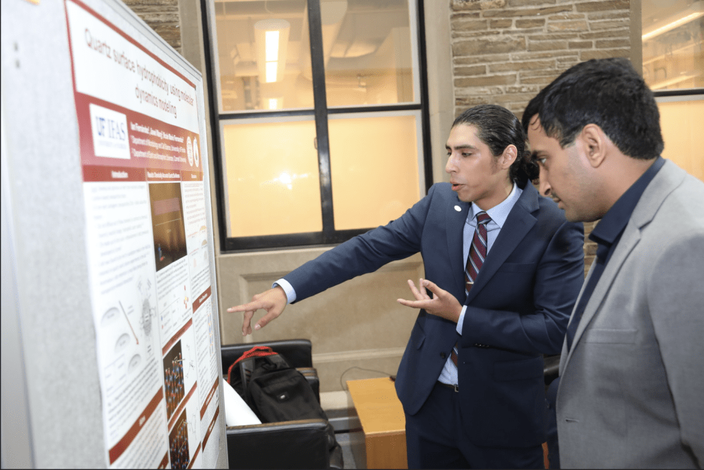 Two students discussing research poster